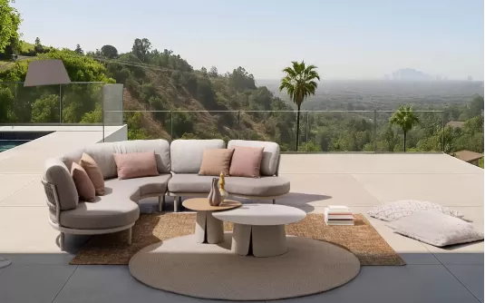 Modułowy aluminiowy narożnik ogrodowy o obłych kształtach Helios bizzotto konstrukcja antracyt poduszki szarobeżowe