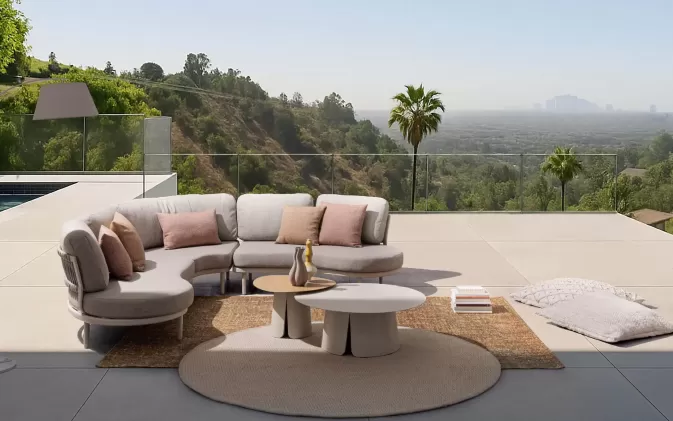 Modułowy aluminiowy narożnik ogrodowy o obłych kształtach Helios bizzotto konstrukcja antracyt poduszki szarobeżowe